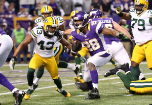 Minnesota Vikings running back Adrian Peterson (28) runs from Green Bay Packers free safety M.D. Jennings (43) during a seven-yard touchdown run in the first half of an NFL football game Sunday, Dec. 30, 2012, in Minneapolis. (AP Photo/Jim Mone)